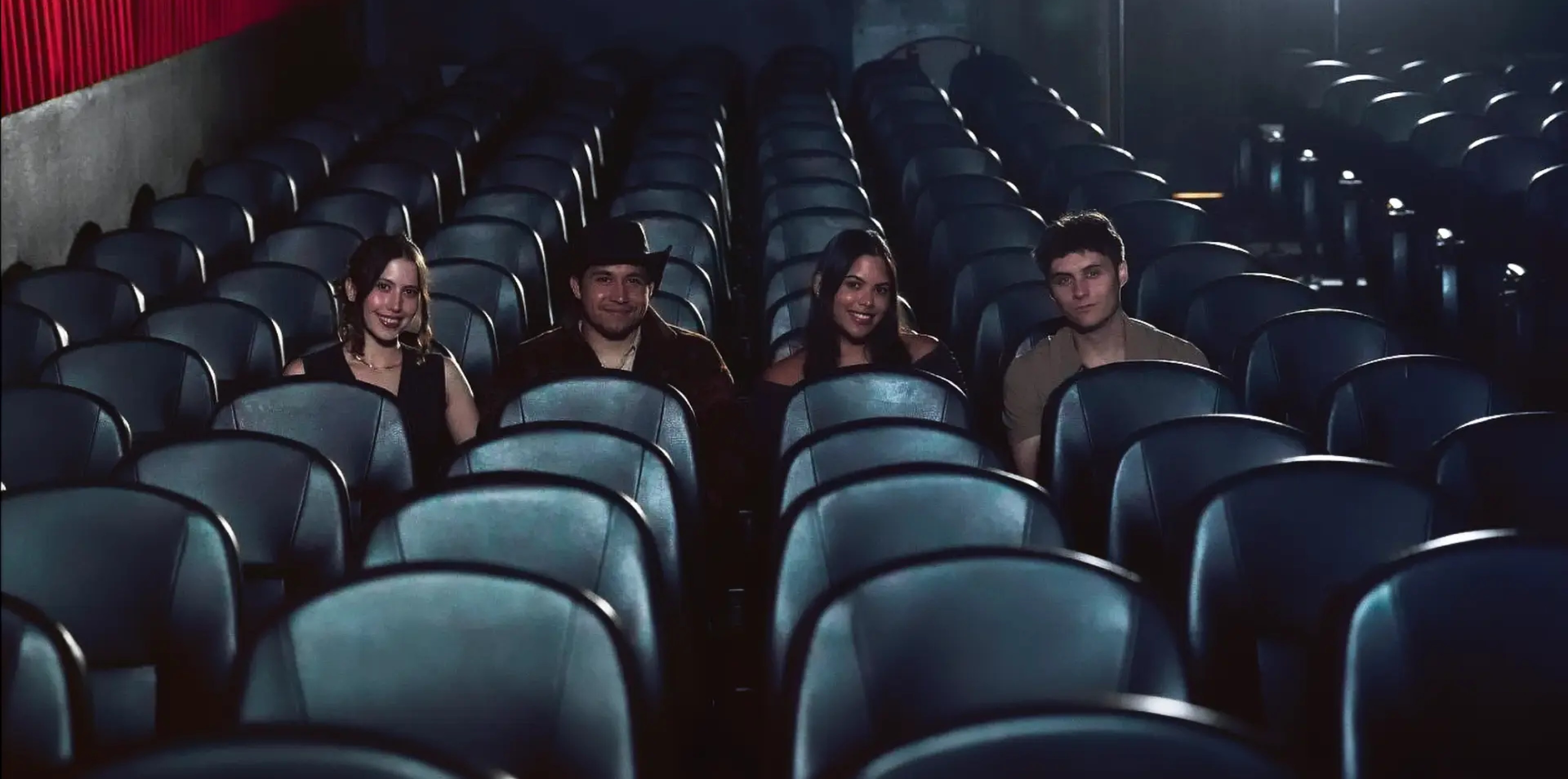 Four members of the Screen Out Loud team seated among the theater seats
